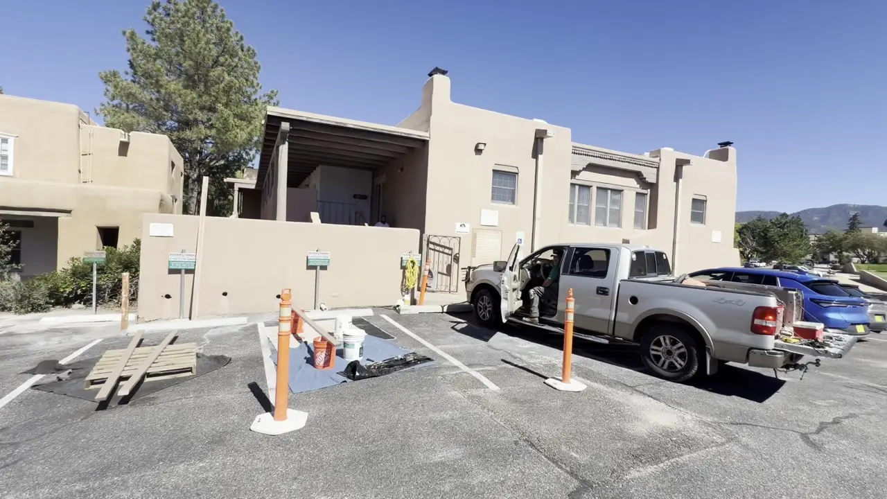 The parking lot beside 300 Galisteo, with the two-story adobe ahead