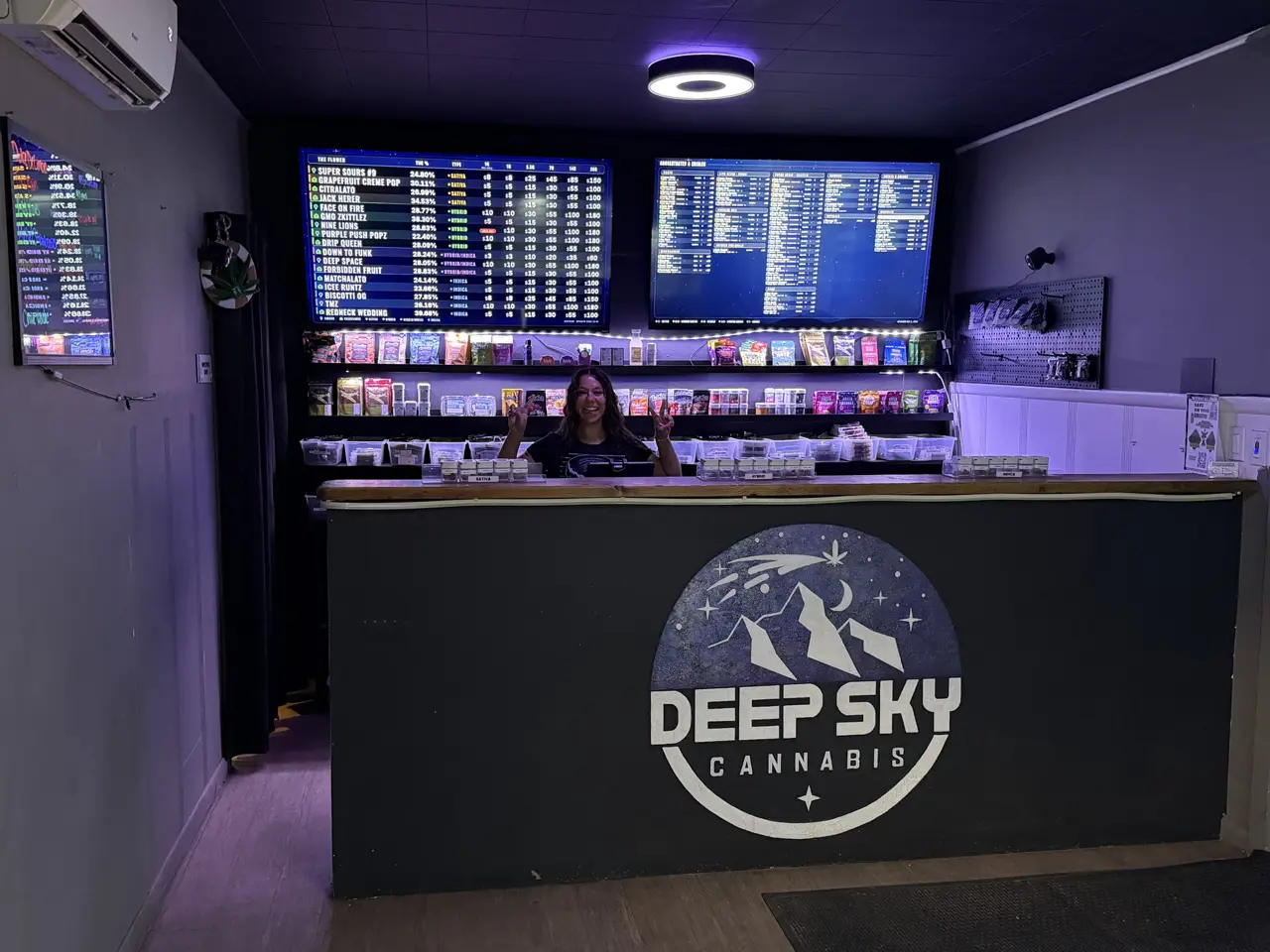 The Deep Sky counter with the logo, the menu screens and a budtender smiling