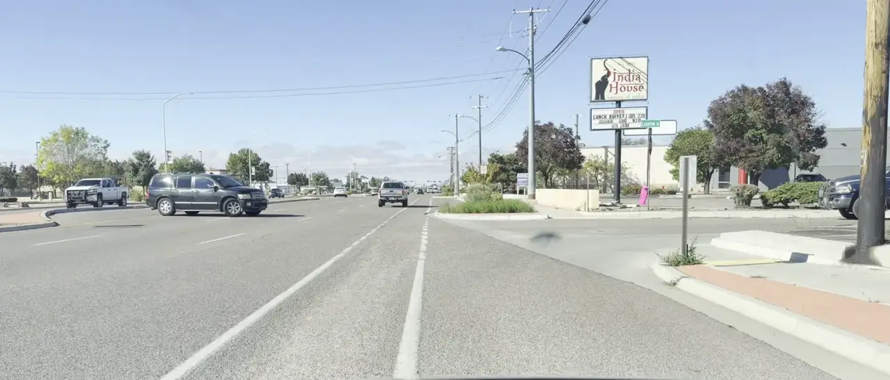 Cerrillos Rd at the turn onto Luana St, with the India House sign